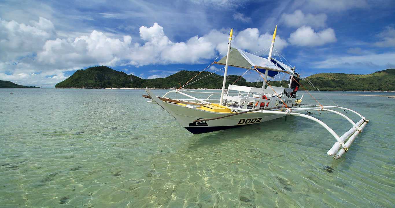 outrigger boat at Bulubadiang Island's shallow waters
